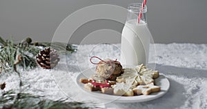 Video of christma cookies, bottle of milk and copy space on white background