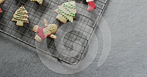 Video of christma cookies decorated sugar icing with copy space on grey background