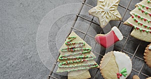 Video of christma cookies decorated sugar icing with copy space on grey background