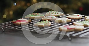 Video of christma cookies decorated sugar icing with copy space on grey background