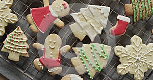 Video of christma cookies decorated sugar icing with copy space on grey background