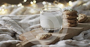 Video of christma cookies, glass of miljk and copy space on white background