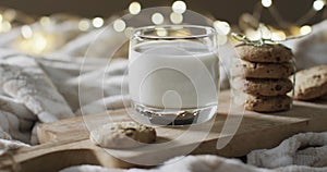 Video of christma cookies, glass of miljk and copy space on white background