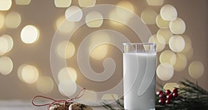 Video of christma cookies, glass of miljk and copy space on wooden background