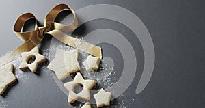 Video of christma star cookies decorated with sugar and ribbon, copy space on black background