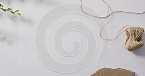 Video of christmas decorations with ball of string on white background
