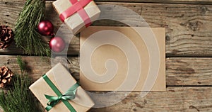 Video of christmas decorations with cards and copy space on wooden background