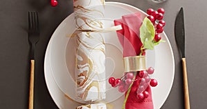 Video of christmas place setting with christmas cracker on grey background