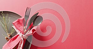 Video of christmas place setting with cutlery and copy space on red background