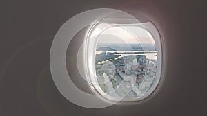 Video of cityscape of modern part of Kyiv, Ukraine from porthole inside airplane.