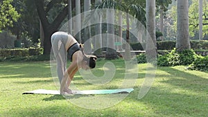 Video clip of a woman practicing Padahastasana, a yoga pose.