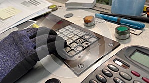 Video close-up of worker operating equipment using remote control during his work at the factory