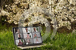 video conferencing on laptop PC in the garden on vacation in summer.