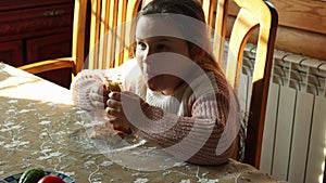 Video cute little girl eat tasty pancakes from the plate, sitting at table in kitchen. Shrovetide, Maslenitsa holiday