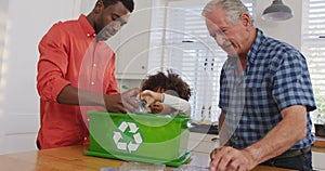 Video of diverse family in the kitchen segregating rubbish