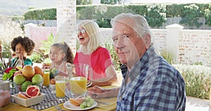 Video of diverse family spending time together and having dinner outside