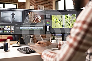 Video editor organizing footage and timelines on computer