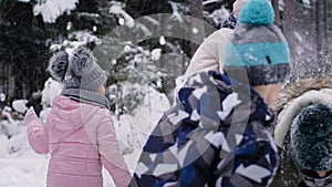 Video of family having a snowball fight in the snow.