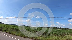 Video footage of car driving on a country road on a sunny day