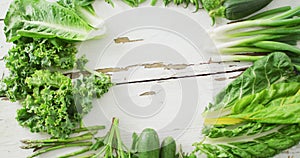 Video of fresh salad leaves with copy space on white rustic background