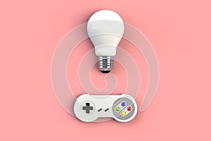 Video game console GamePad. Gaming concept. Top view retro joystick with light bulb isolated on pink background