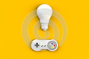 Video game console GamePad. Gaming concept. Top view retro joystick with light bulb isolated on yellow background