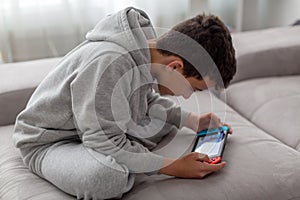 Video game console for home or portable gaming. Teenager man playing game on console.