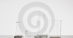 Video of glass laboratory beakers and dishes with copy space on white background