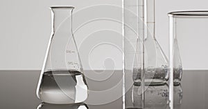 Video of glass laboratory beakers and dishes with copy space on white background