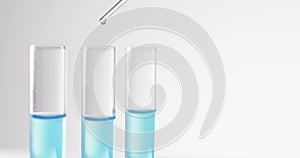 Video of glass laboratory test tubes and pipette with blue liquid and copy space on white background