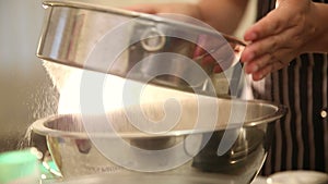 Video hand Sifting dusting flour with light setting