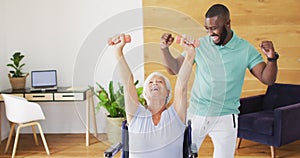 Video of happy african american male physiotherapist exercising with caucasian senior woman