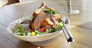 Video of healthy appetising meal with roast chicken, sauce and salad on wooden dinner table