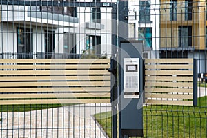 Video intercom on the gate at the entrance to the residential area photo