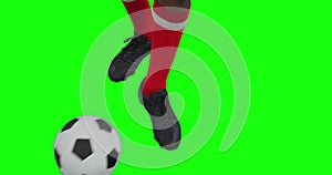 Video of legs of african american male soccer player kicking ball on green screen background