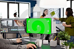 Video maker editing movie at pc with green screen