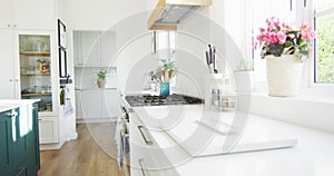 Video of modern, luxury domestic kitchen with white units and wooden floor, copy space