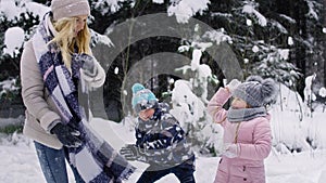 Video of mother and two children having snowball fight.