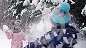 Video of mother and two children having snowball fight.