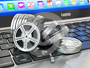 Video or movie online internet concept. Film reels on laptop key