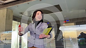 video portrait of a Latina businesswoman celebrating a success outside her office