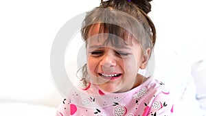 Video portrait of little toddler girl crying with mouth wide open and tears down her face. Isolated on white background