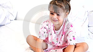 Video portrait of little toddler girl crying with mouth wide open and tears down her face. Isolated on white background