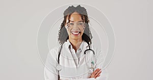 Video of portrait of smiling biracial female doctor with arms crossed