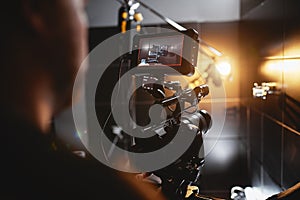 Video production backstage. Behind the scenes of creating video content, a professional team of cameramen with a