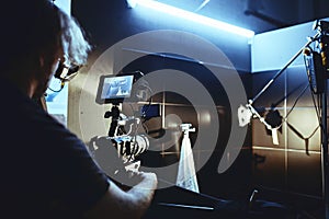 Video production backstage. Behind the scenes of creating video content, a professional team of cameramen with a