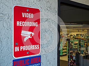 Video recording in progress security sign at public area in front of store