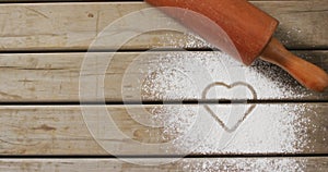 Video of rolling pin and heart shape in flour on wooden surface