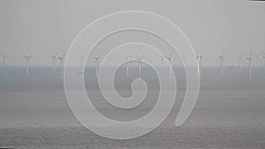 Video, rows of wind turbines in sea.