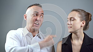 Video of screaming man at woman on grey background